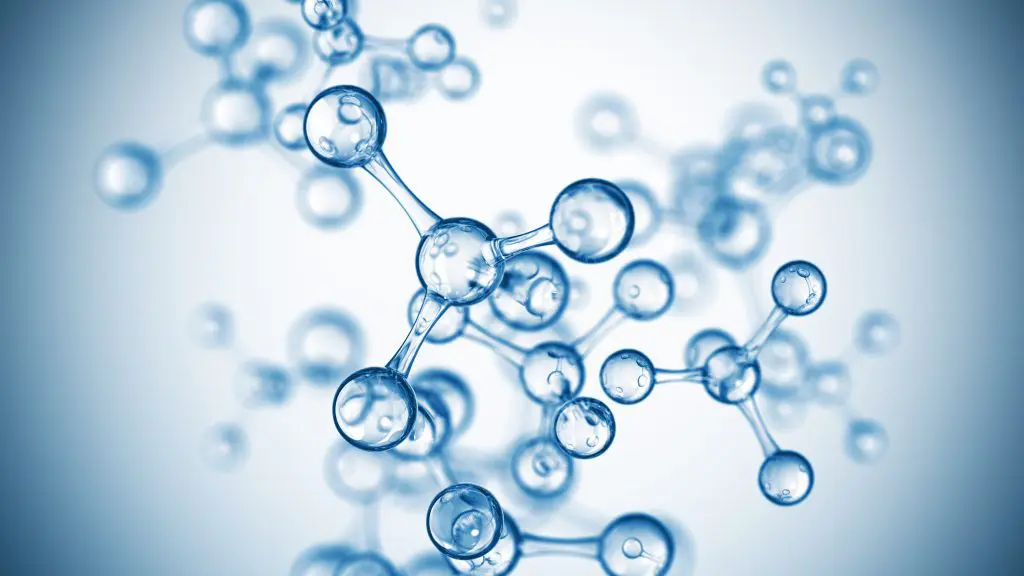 Translucent blue 3D molecular model with glass-like spheres connected by bonds on a soft white-to-blue background
